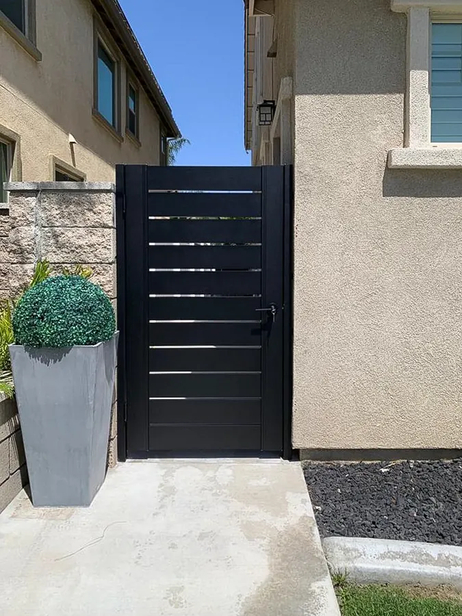 Black side-yard pedestrian metal gate