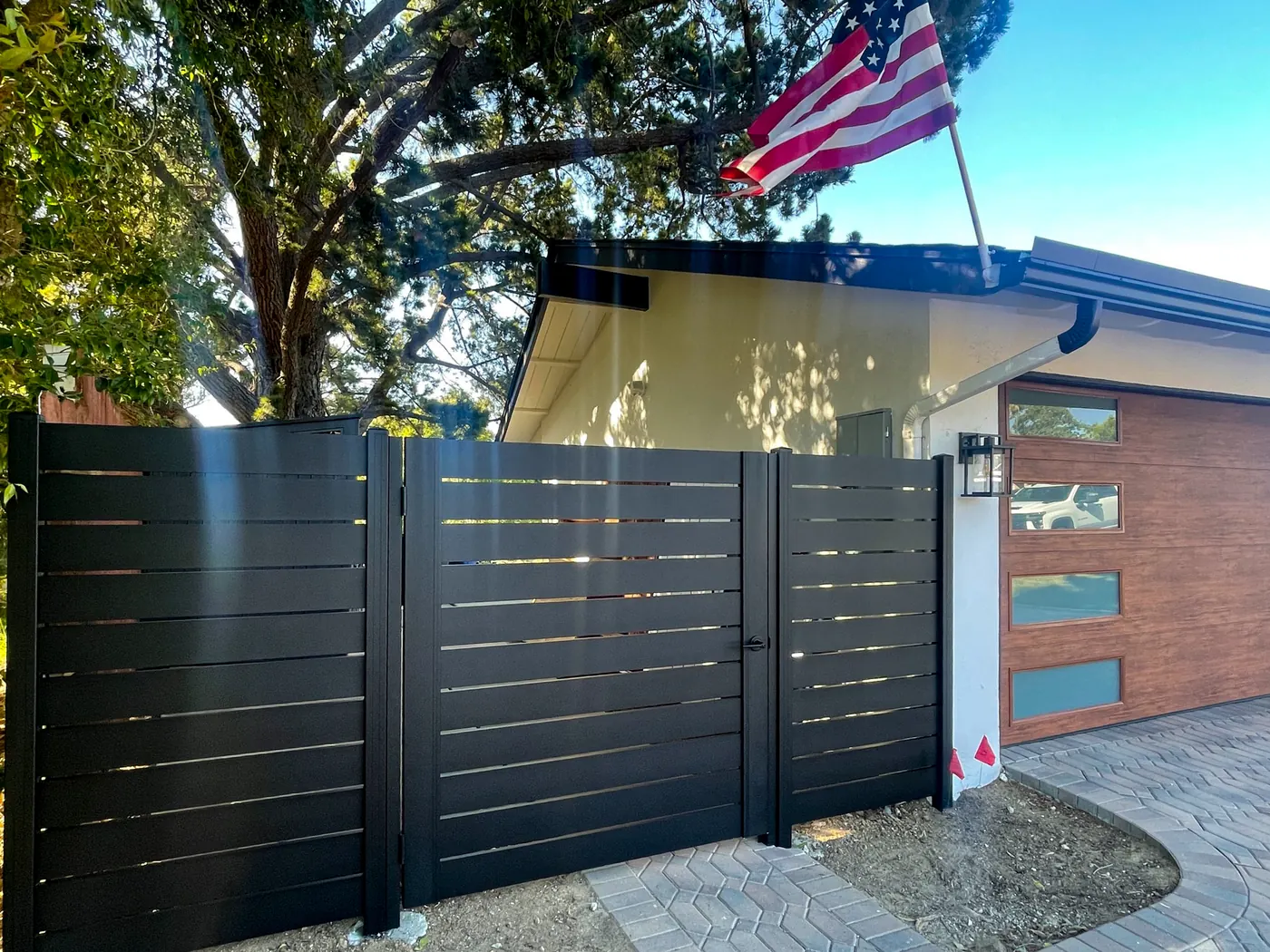 Modern black metal side-yard gate and fence